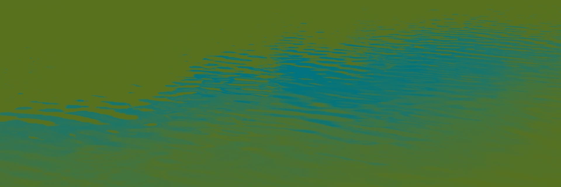 Ripples on the surface of calm water, reflecting shades of blue and green.